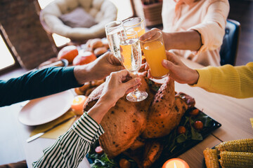 Poster - Cropped photo of four friendly family members arms hold champagne juice clink celebrate thanksgiving dinner apartment indoors