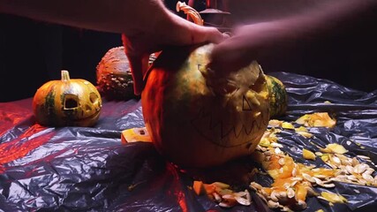 Wall Mural - time-lapse video cutting art scary halloween pumpkins and old kerosene lamp in red backlight preparation for celebration in dark room