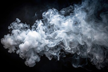 Low angle view of white smoke puffs against dark background