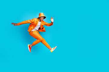 Wall Mural - Photo of crazy carefree guy jumping look empty space wear stylish trendy outfit isolated cyan color background