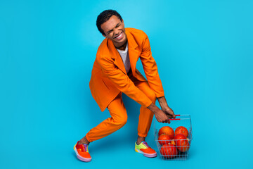 Poster - Photo of guy grab basket with pumpkins buy market on thanksgiving feel tired heavy isolated blue color background