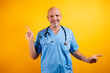 © karrastock - A doctor pointing left and right with his fingers.
