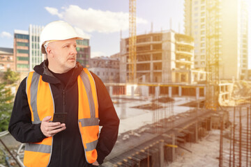 Poster - man foreman. builder with phone in hands. architect multi-storey buildings. man builder near block u