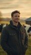 © Michal - Attractive man in his thirties, smiling and standing on a farm with cows behind him