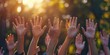 © Creations Photo  - A group of hands raised in the air, symbolizing participation and engagement