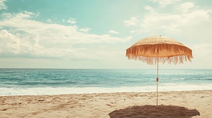 Wall Mural - Retro fringe bone beach umbrella parasol on sand beach with windy sea waves cloud sky in earthy natural color vacation relaxation seaside coast resort ocean vibes eco summer holiday tropical campaign 