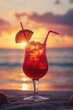 © vefimov - Sunset drink on sandy beach with straw and slice of lemon. Vibrant colors, relaxing ambiance.