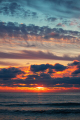 Wall Mural - beautiful cloudscape over the sea, sunrise vertical shot