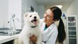 © Iona - A woman in a white coat shares a joyful moment with a happy dog in a veterinary clinic, highlighting care and companionship.