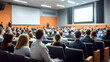 © Daniel - Business people or students are watching a presentation or attend a training or seminar in a lecture hall or auditorium. Conference hall full of people participating in the business training