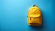 © khafid - Yellow bag with copy space on blue background. Back to school background with bag and school equipment supplies