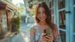 © nataliya_ua - A young woman enjoys a sunny day outdoors while texting on her smartphone in a vibrant urban setting. Generative AI