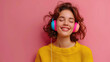 © Saim Art - Girl listening to music with headphones against pink background