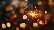 © DruZhi Art - Close-up of Burning Sparkler in Hand with Golden Bokeh Lights Background for New Year Celebration