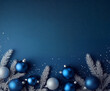 © CheeSiong - Christmas border composition with blue and silver ornaments and frosted fir branches on a classic blue background