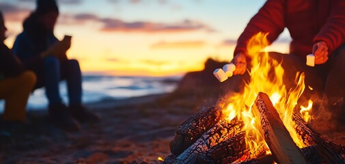 Friends enjoying a campfire on the beach at sunset, roasting marshmallows.