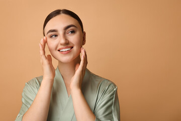 Canvas Print - Beautiful young woman with healthy skin on beige background, space for text