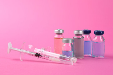 Canvas Print - Pharmacist. Glass vial with medication and syringes on pink background