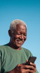 Poster - A man is smiling while looking at his cell phone