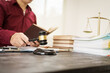© NanSan - A male lawyer is working at his desk on an online judicial review, focusing on justice, fairness, and legal compliance.He reviews cases, contracts, and legal matters based on general law principles