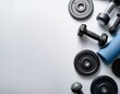 © Tedi S Photography - flat lay of fitness equipment including weights on a white surface and background with copy space