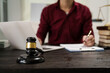 © NanSan - A male lawyer is working at his desk on an online judicial review, focusing on justice, fairness, and legal compliance.He reviews cases, contracts, and legal matters based on general law principles