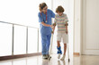 © famveldman - Injured child on crutches. Boy in cast on foot