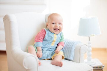 Wall Mural - little baby on white chair