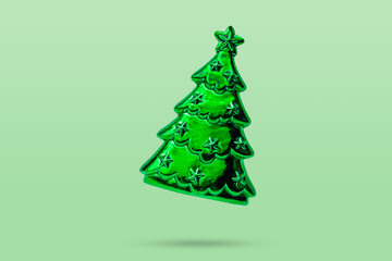 Wall Mural - Green Christmas tree ornament bauble isolated on green background
