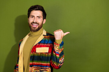 Poster - Photo of cheerful handsome nice man wear trendy coat demonstrate empty space isolated on khaki color background