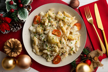 Wall Mural - Macaroni and cheese with cauliflower. Top view table with Christmas decoration.