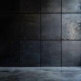 A black wall with a grey floor. The wall is made of metal and has a greyish color