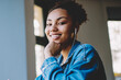 © BullRun - Concept of multitasking and enjoyment, portrait of cheerful afro american meloman sitting on publicity area and listening favourite positive music playlist via electronic earphones with high volume