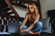 © InsideCreativeHouse - Middle aged caucasian woman using laptop on sofa at home