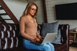 © InsideCreativeHouse - Adult caucasian woman using laptop computer at home in living room