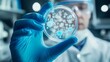 © Rick Cranches - A doctor holds and examines a petri dish with a bacterial culture. A petri dish full of microbes and microorganisms