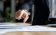 © JP STUDIO LAB - Close-up of a consultants hand pointing at a financial report, documents scattered on a desk, professional hand gesture, finance and consulting, good fingers, good hand