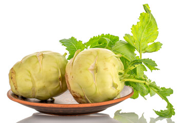 Wall Mural - Two ripe kohlrabi sprouts on a clay plate, macro, isolated on white background.