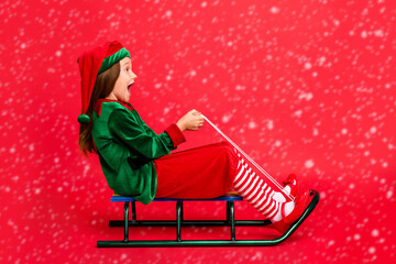 Sticker - Full length profile side photo of excited elf kid in hat with long red head haircut sledding screaming wearing cap costume isolated over red background