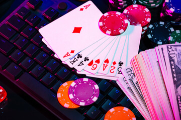 Sticker - A vibrant arrangement of poker chips and playing cards on a gaming keyboard with a mouse at an online casino setup during the evening