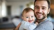 © JW Studio - Smiling young father holding his happy baby, perfect for family moments, parent-child bond visuals, and happy family photography