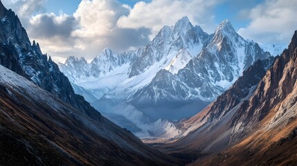 Breathtaking snow capped mountain range with rugged jagged peaks reaching towards the sky towering over a vast untamed wilderness landscape  A cinematic