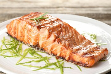 Delicious grilled salmon fillet served on table, closeup