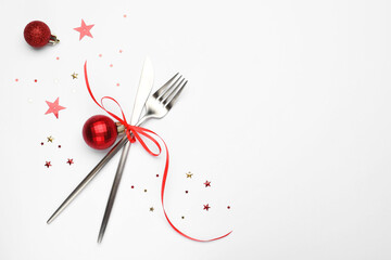 Wall Mural - Christmas table setting. Cutlery and festive decor on white background, flat lay. Space for text