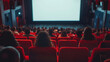 © Alexander - Cinema experience blank wide screen with red chairs and blurred silhouettes of audience in a movie hall