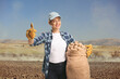 © Ljupco Smokovski - Young female farmer holding potatoes in a sack and gesturing thumbs up