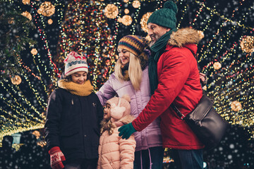 Canvas Print - Photo of cute shiny wife husband school girl boy enjoying xmas time embracing outdoors city fair