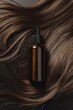© Darya Lavinskaya - A dark brown bottle with a spray nozzle on a rich bed of wavy, dark brown hair