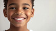 © wernerimages - A young boy smiles joyfully, exuding delight and warmth against a simple background, reflecting innocence and the pure happiness of childhood moments.