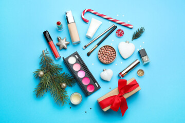 Canvas Print - Flat lay composition with makeup products and Christmas decor on light blue background